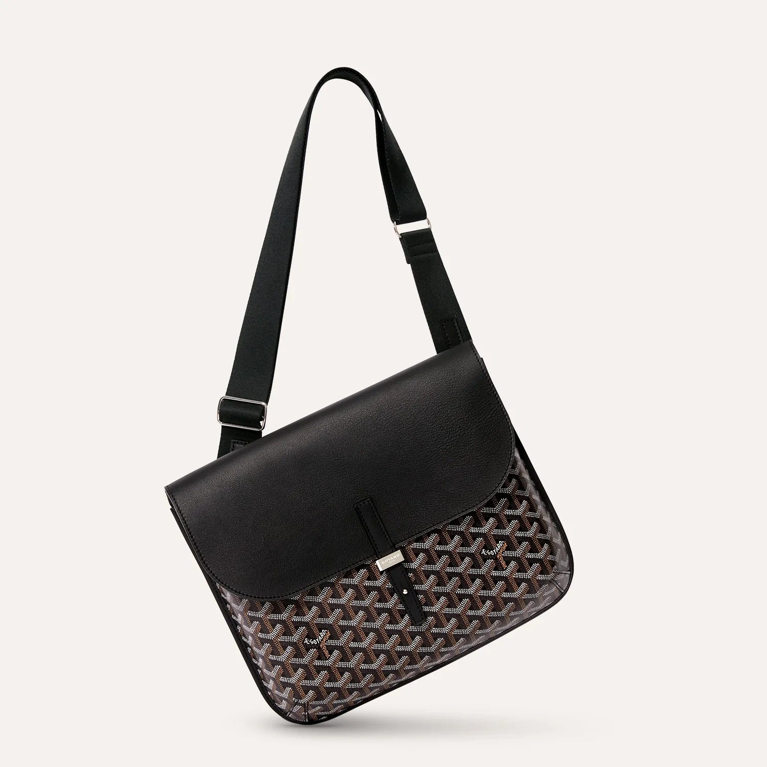 Side angle view of luxury Goyardine canvas messenger bag in black