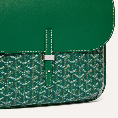 Close up detail of green leather flap and metallic buckle on Goyardine messenger bag