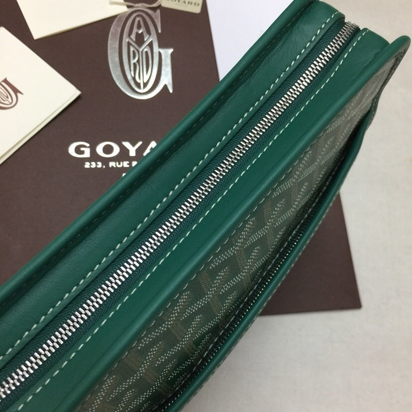 Side view detail of green Goyardine canvas toiletry pouch